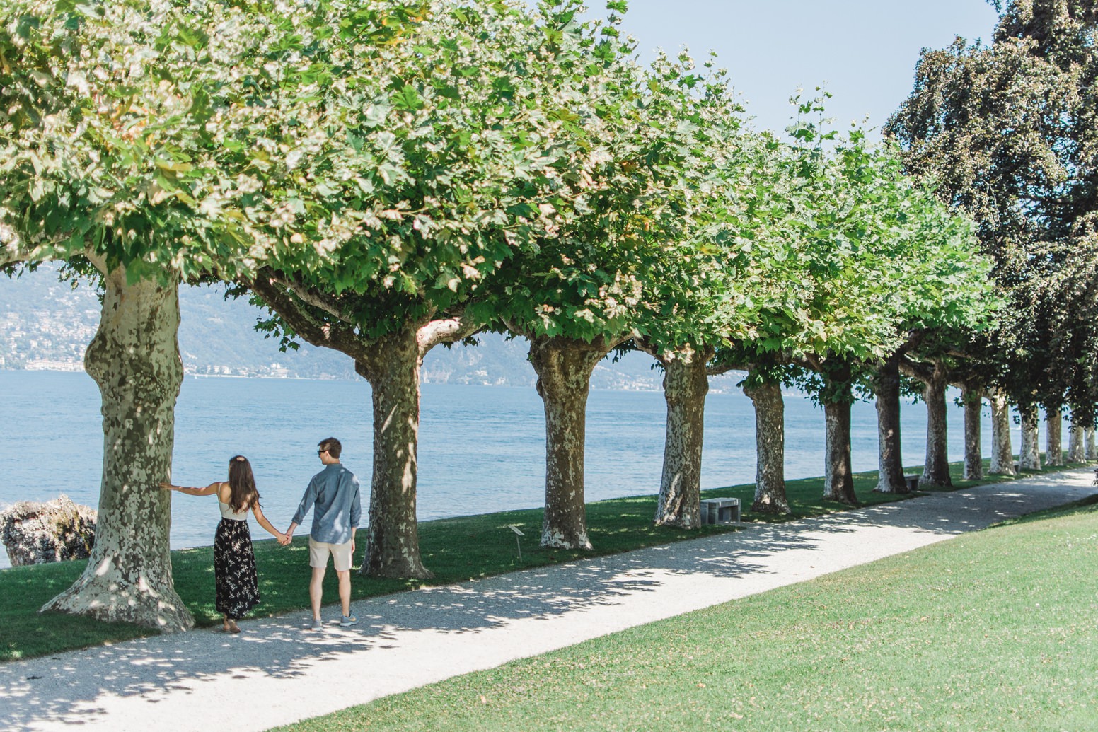 Engaged couple walking around Lake Como