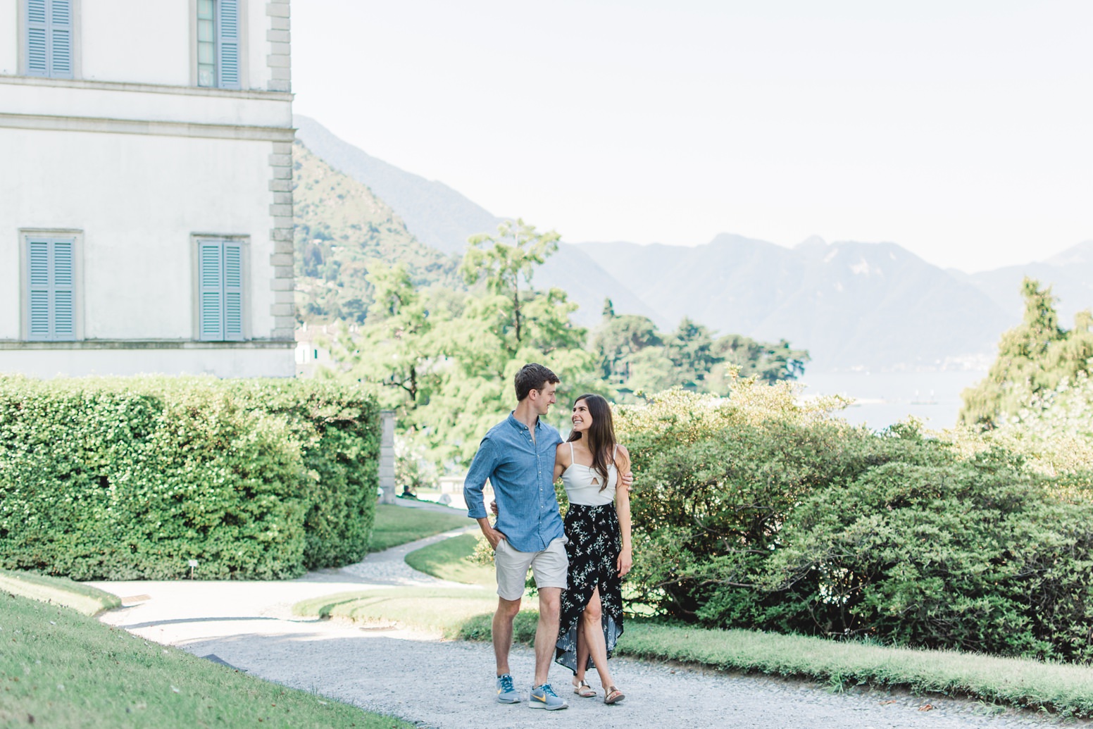 Couple walking and hugging along Lake Como