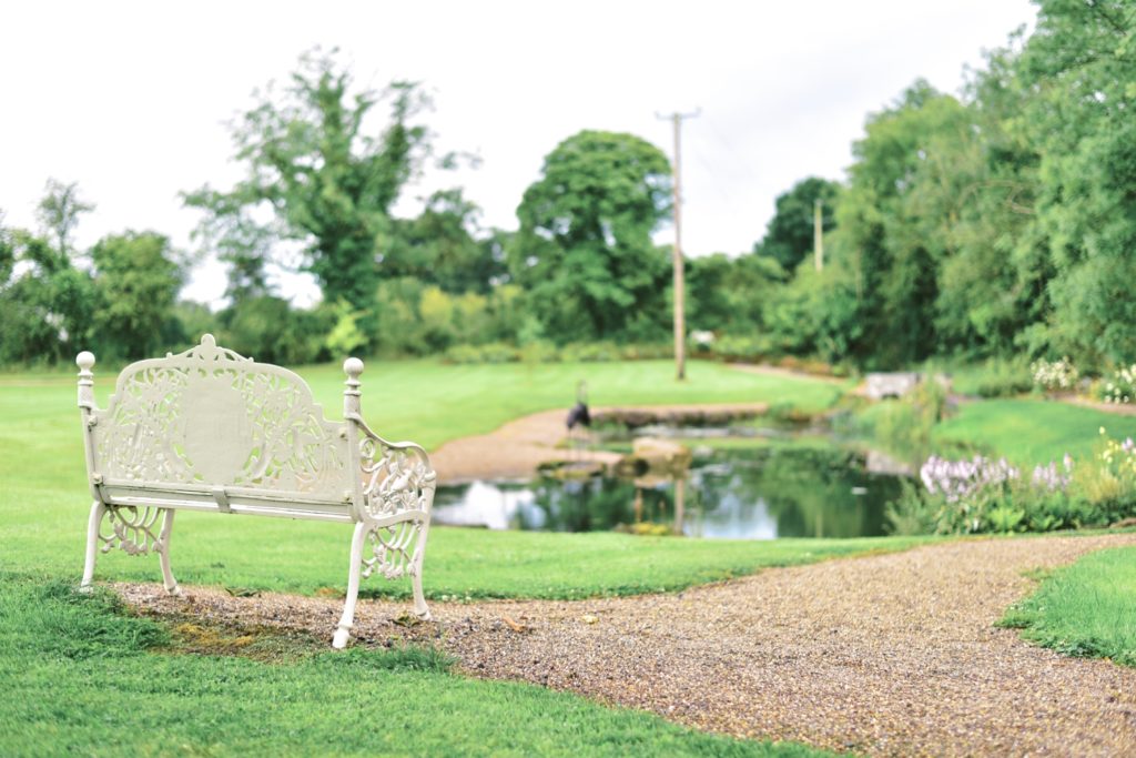 A quiet bench overlooking the serene pond at Clonabreany House, Meath.