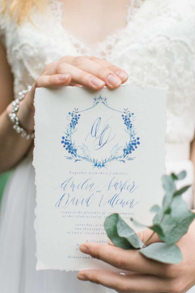 Bride holding wedding invitation with calligraphy