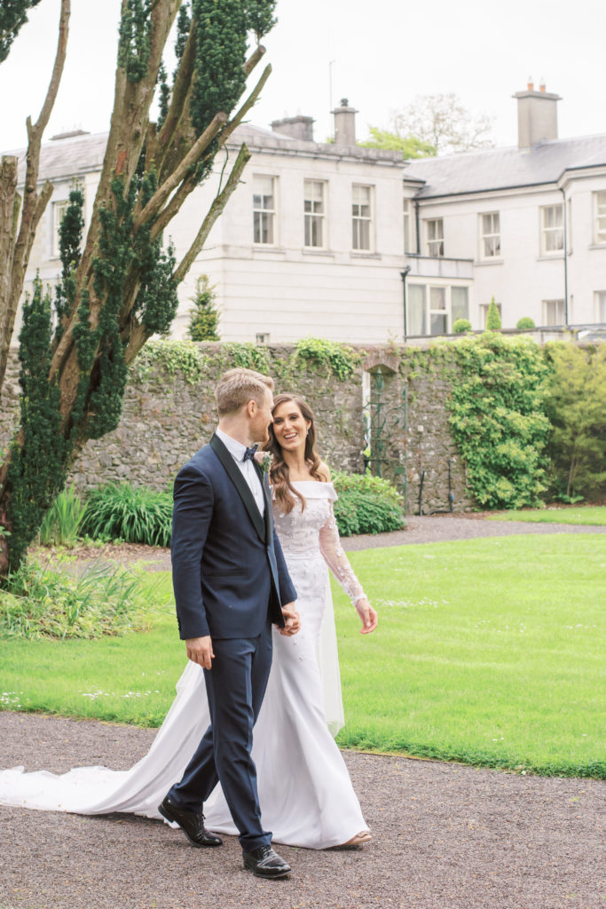 Bride and Groom stroll through Tankardstown House's beautiful Walled Garden.