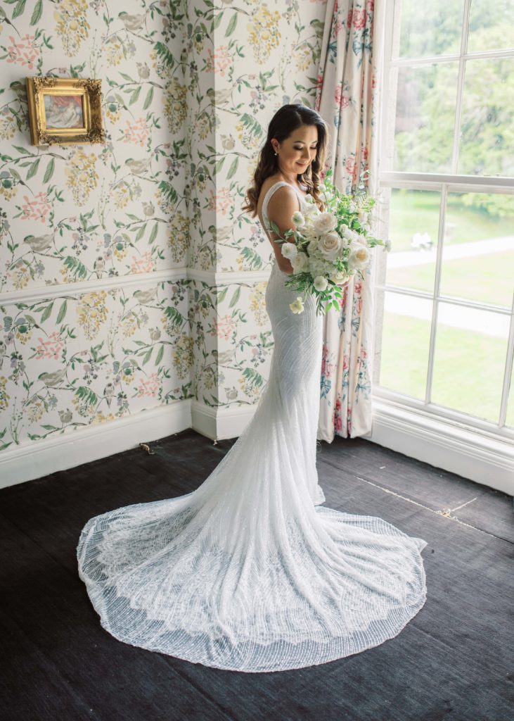 Bride's portrait in wedding dress with bouquet at Killruddery