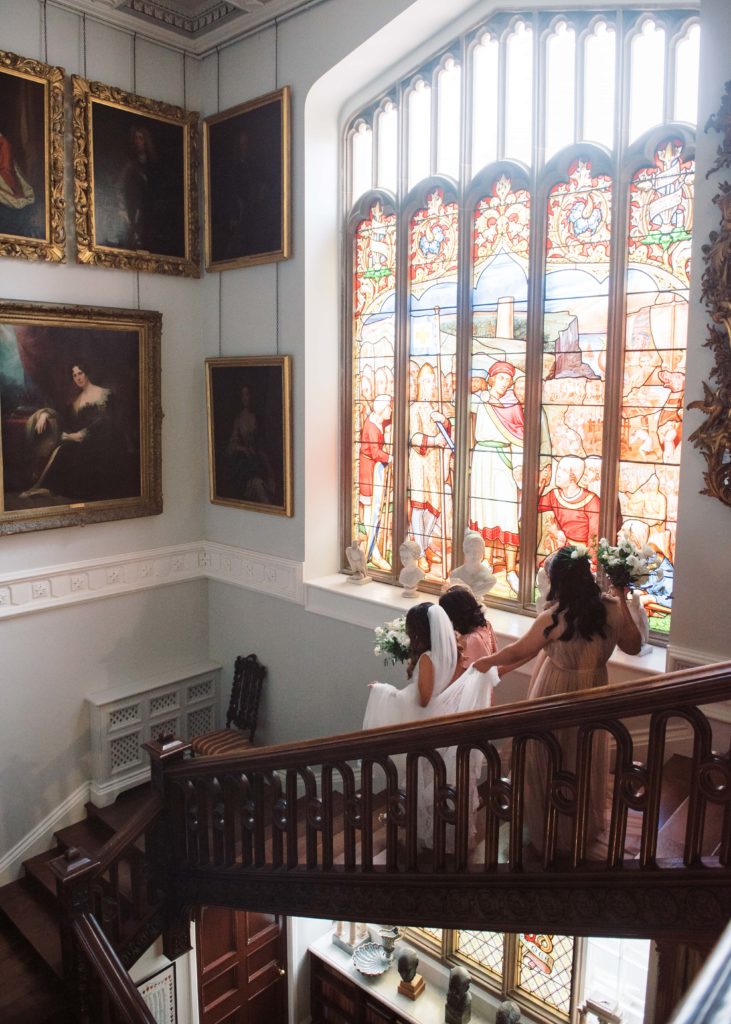 Bride descends stairs in Killruddery House