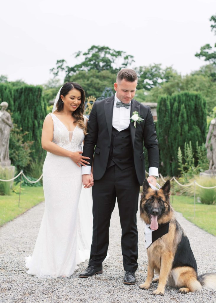 Bride and Groom pose with dog on Wedding Day