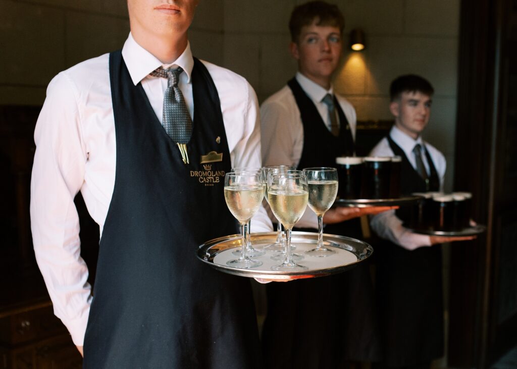 Dromoland Castle waiting staff offer drinks to guests arriving from Wedding ceremony.