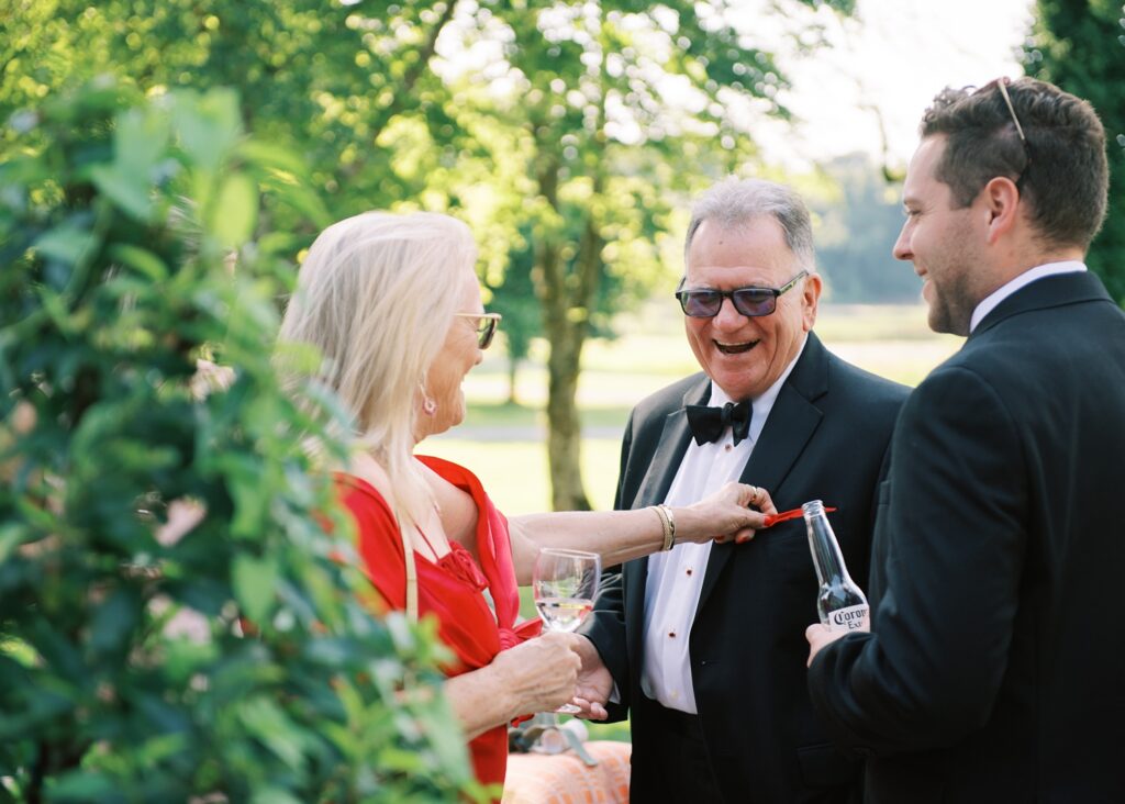 Wedding guests have a great time at the drinks reception at Dromoland Castle Hotel, Ireland.