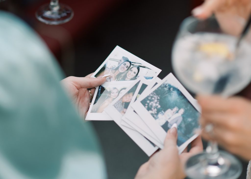 Guests thumb through old family photos at couple's Dromoland Castle wedding party.