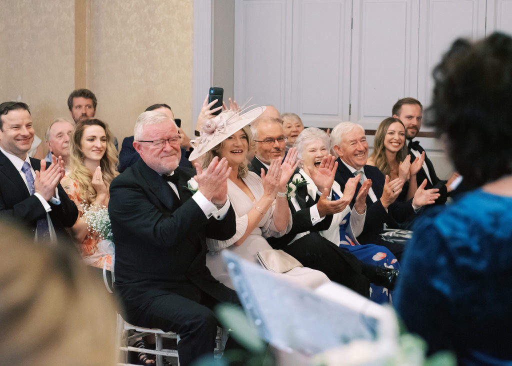 Bride and Groom's family cheer at wedding ceremony.