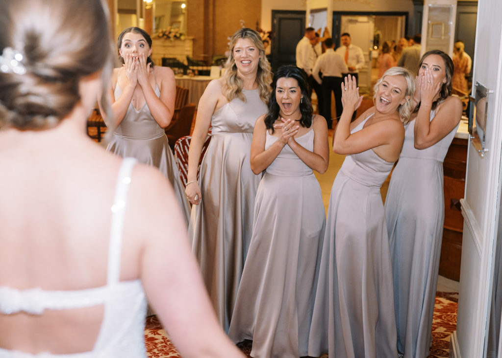 Bride surprises her bridesmaids with dramatic dress change!