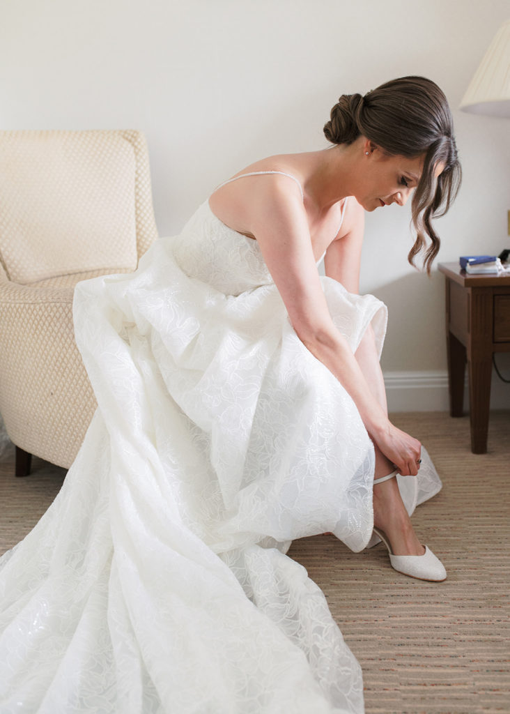 Bride putting on her heels on wedding morning at the Ardilaun Hotel, Galway.