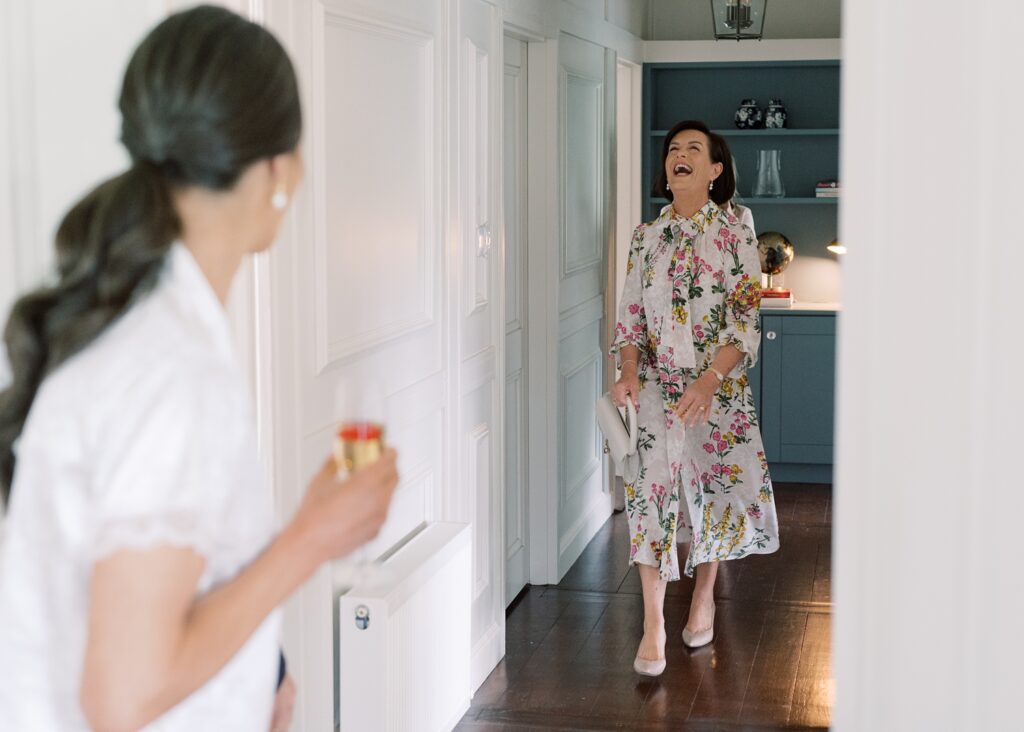Bride and her mother laughing on the morning of her summer wedding. What a loving family!