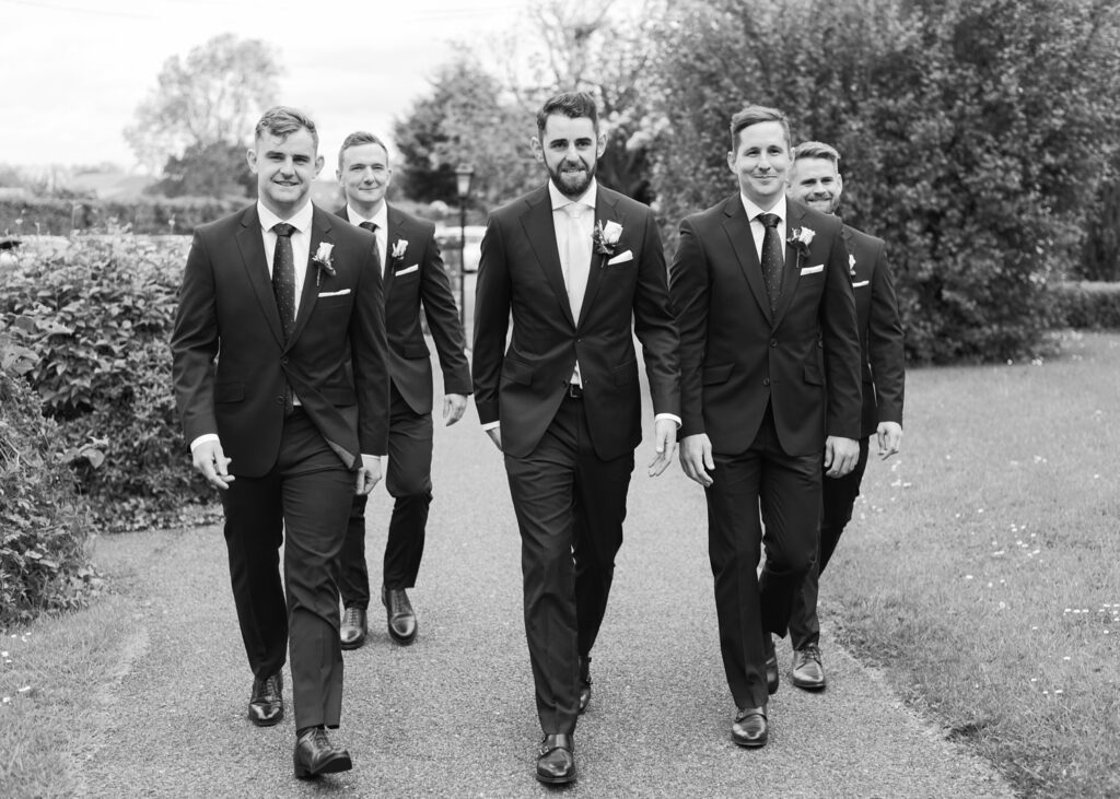 Groom with his groomsmen marching up to the church for their wedding ceremony.