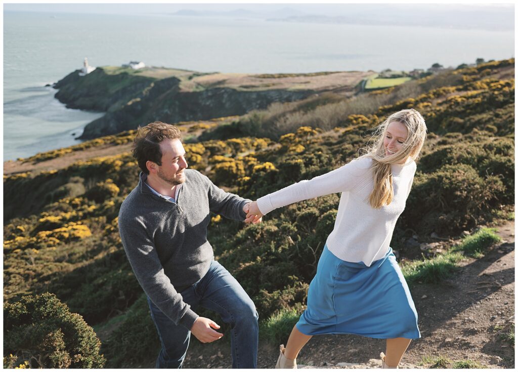 Beautiful airy portrait of Emily and Jacob climbing Howth Hill together.