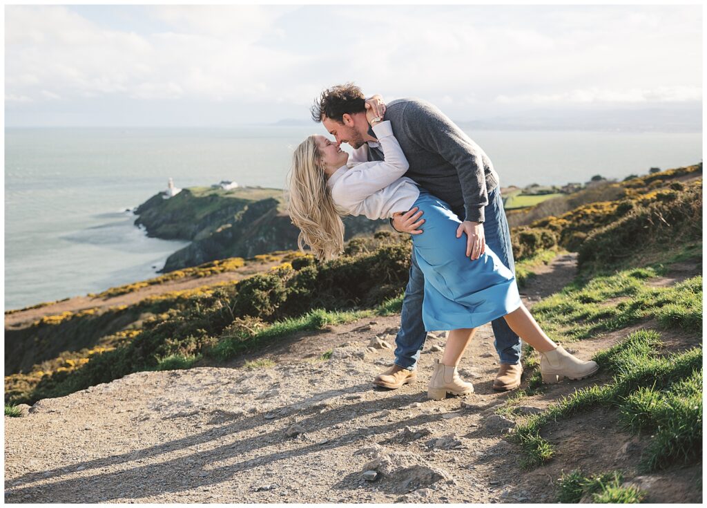 Couple dance atop Howth Summit during their Engagement Session in Dublin, Ireland.