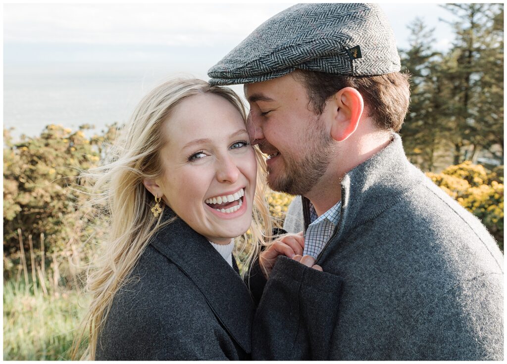 Close up portrait of Emily and Jacob hugging and laughing during their engagement session in Howth, Ireland.