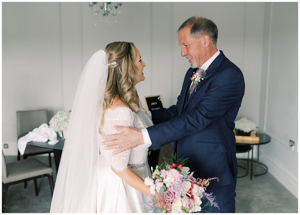 Father of the bride is emotional seeing his daughter in her wedding dress for the first time.