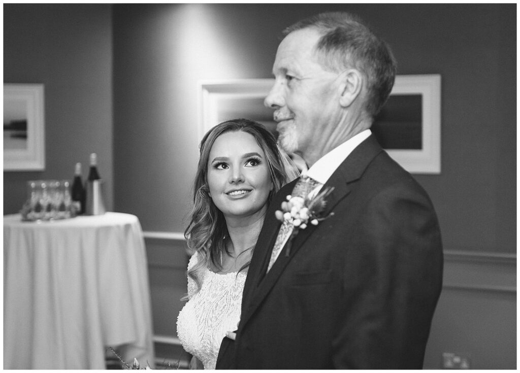 Emotional black and white photo of the look between father and daughter as bride is about to be married.