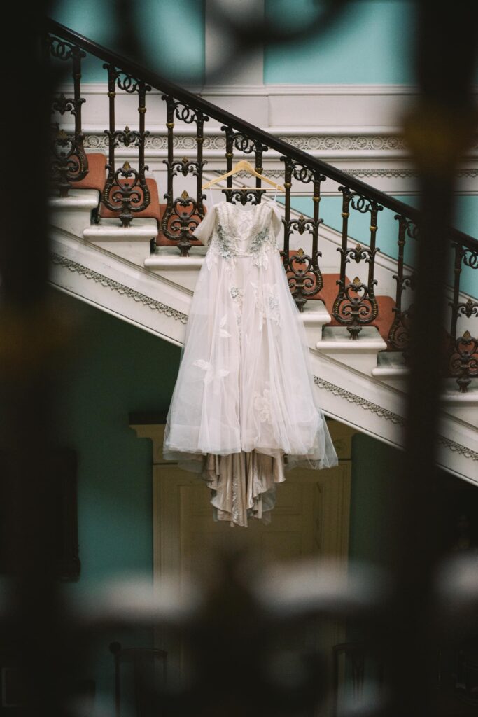 Bride's dress hangs from the banister inside Temple House's foyer.