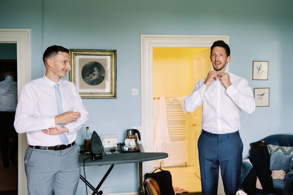 Groomsmen getting ready in the morning of the elopement at Temple House.