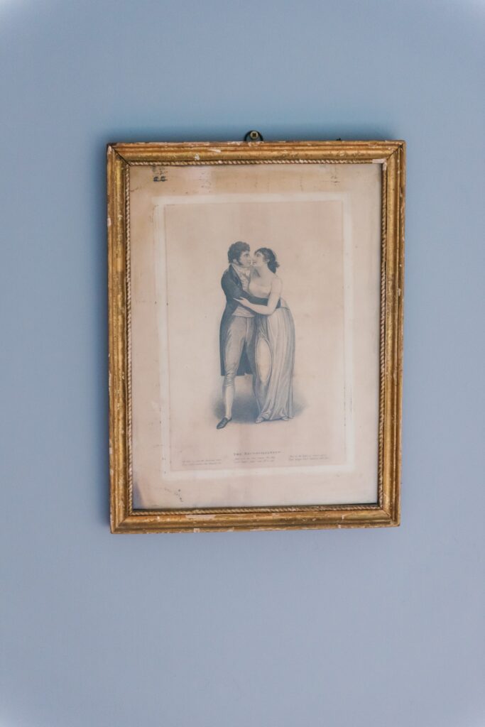 Antique illustration of a dancing couple hangs on a lavender wall in Temple House, Sligo.