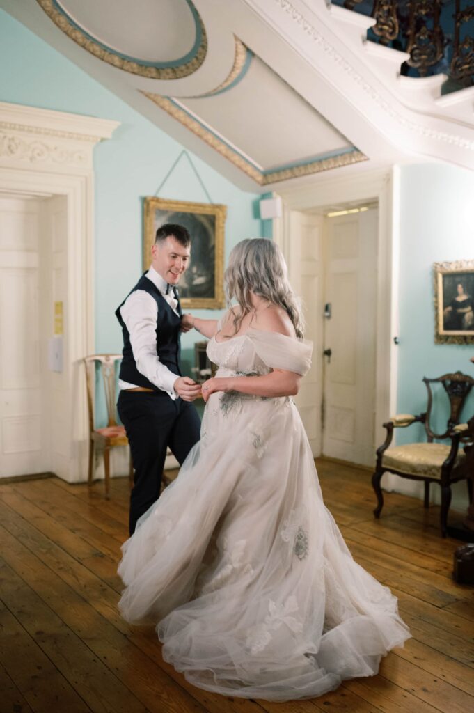 The bride's beautiful dress swishes elegantly as she dances with her husband on their elopement to Temple House.