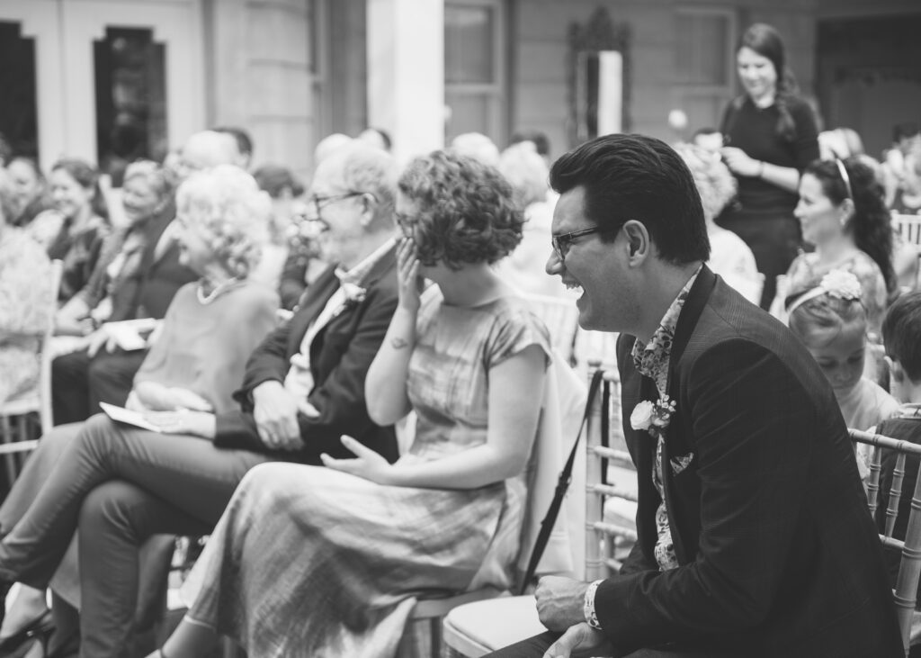 Guests burst with laughter and joy during the same-sex wedding ceremony.