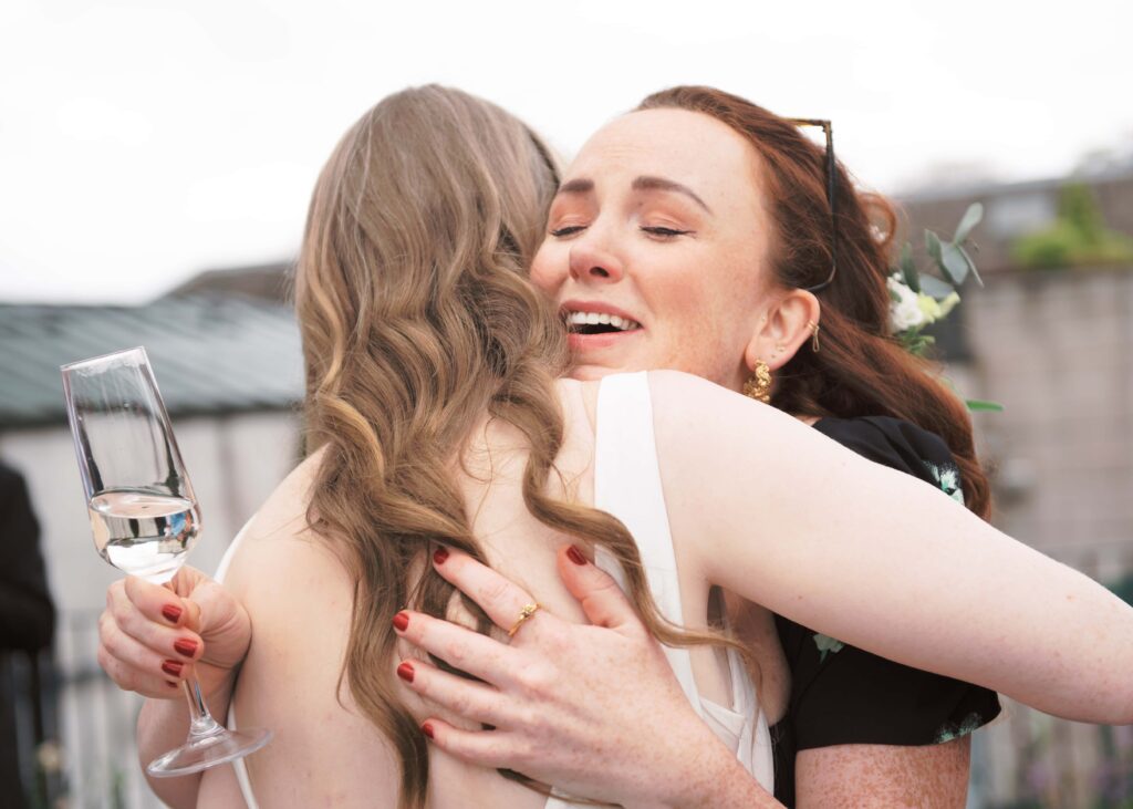 A guest emotionally embraces the bride after the wedding ceremony in Tankardstown.