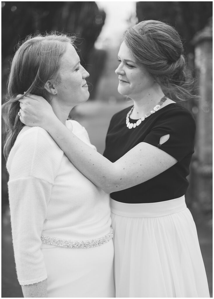 Emotional black and white portrait of a same-sex couple sharing an emotional moment in the Walled Garden.