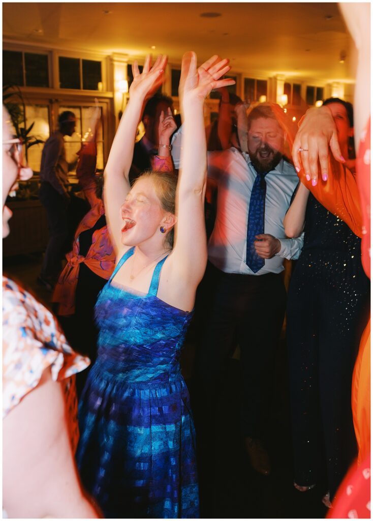 Excited wedding guests partying on the dance floor