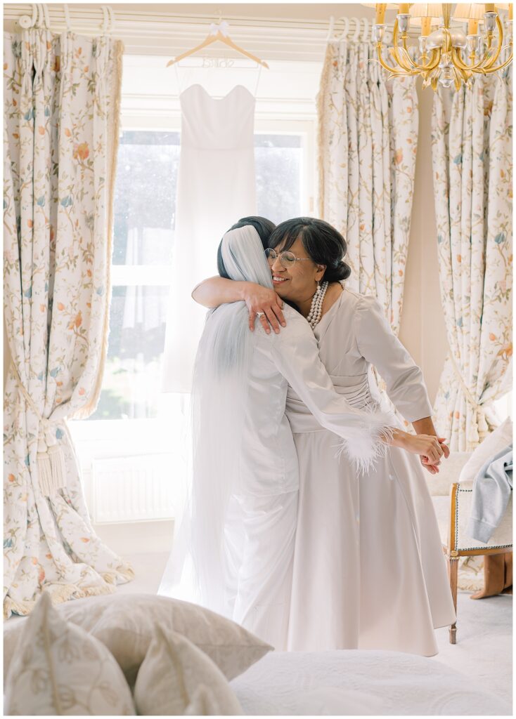 Bride and her mother dance and embrace on the morning of her wedding.
