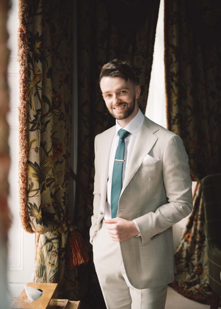 Groom's portrait at the window of the Library Suite in Tankardstown House.