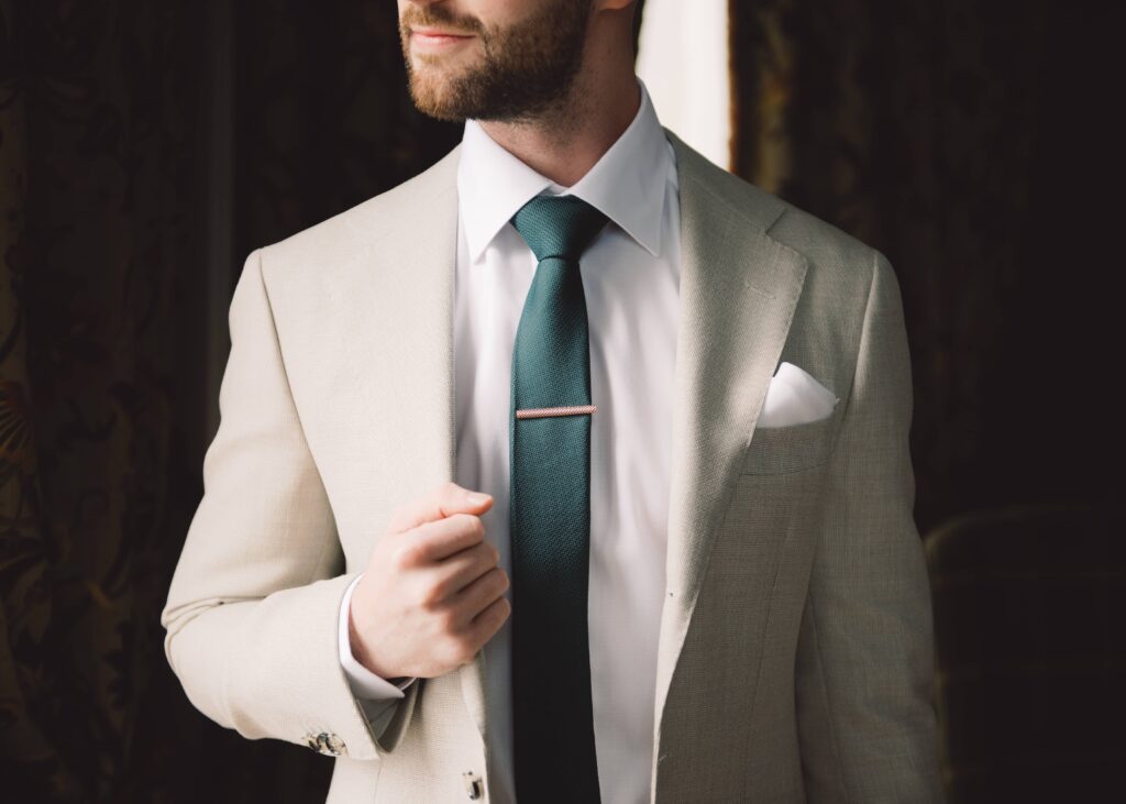 Portrait of Groom in his dapper suit on the morning of his autumn wedding.