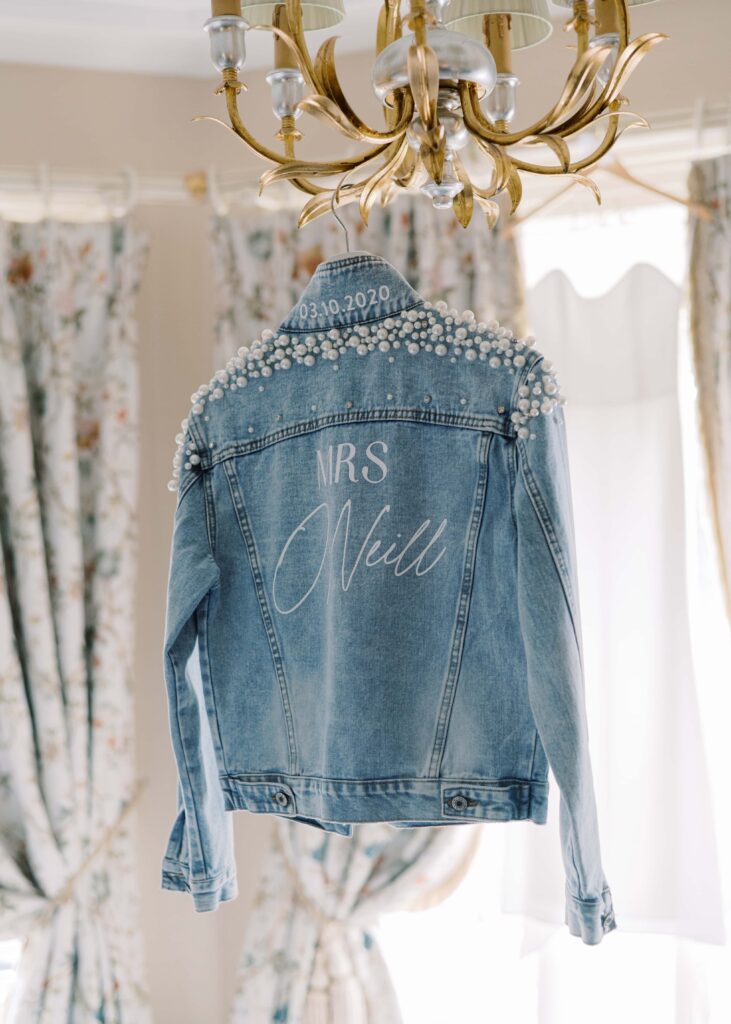 Bride's embroidered demin jacket hangs from the candelabra in Tankardstown House's Master Suite.