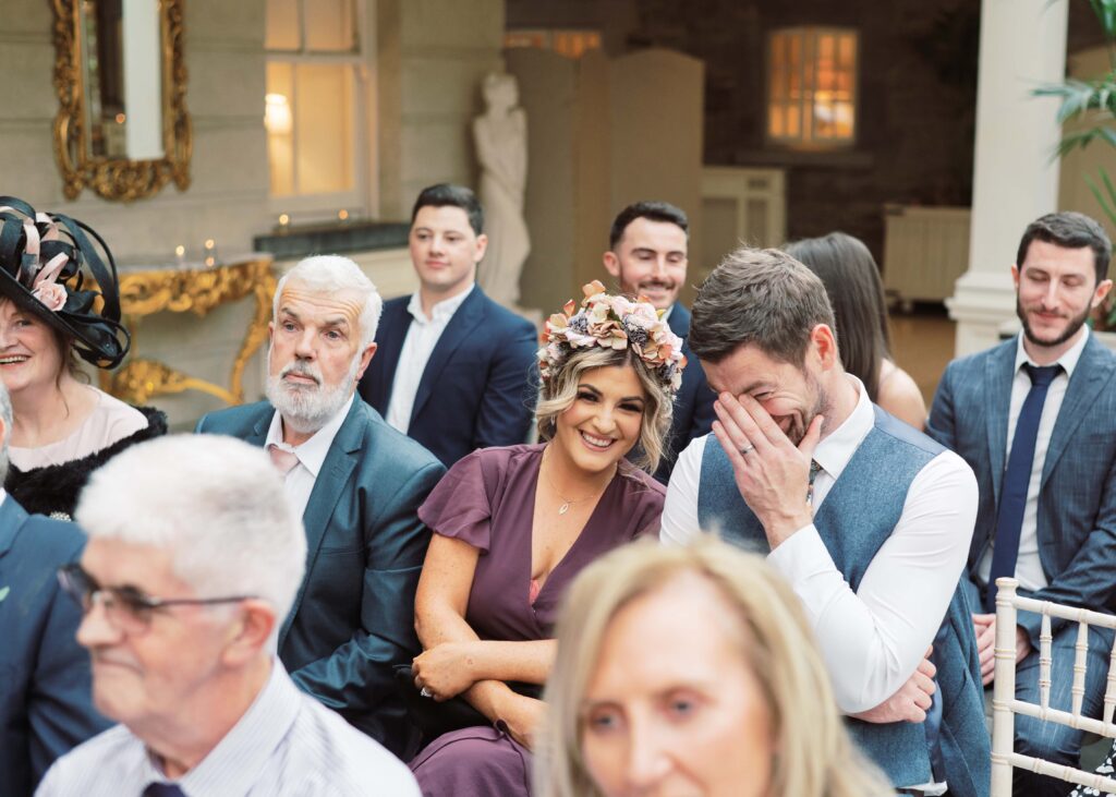Happy guests share a giggle during the fun and delightful ceremony.