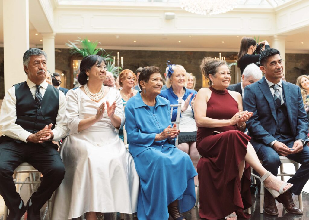 Guests cheer during a beautiful autumn wedding inside Tankardstown House, Ireland.