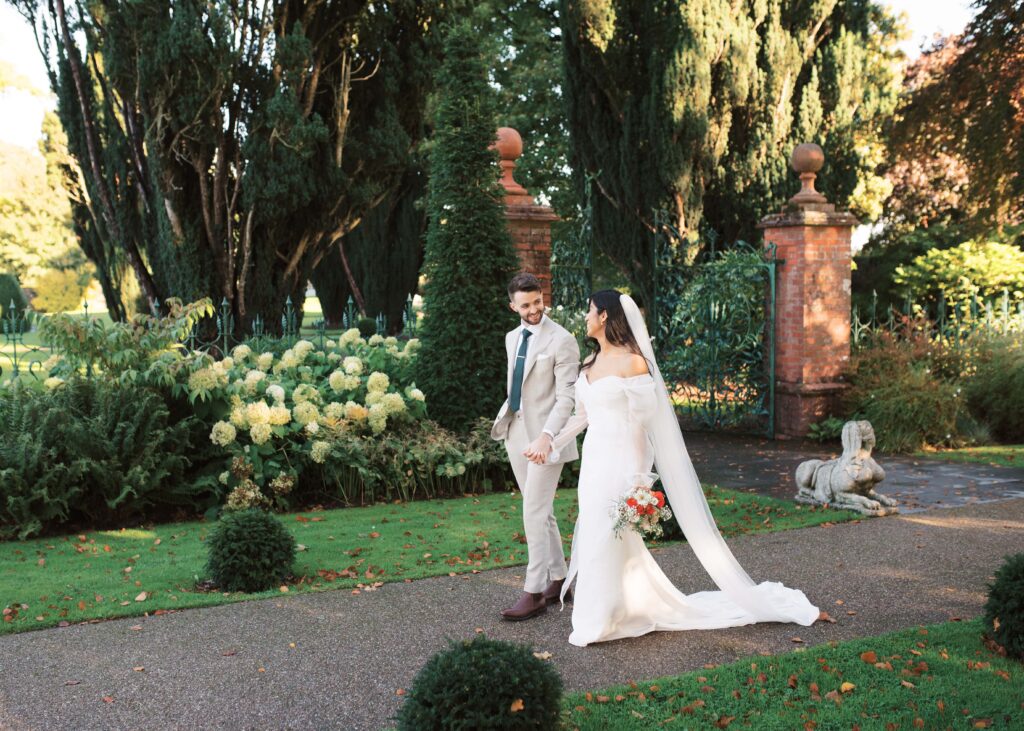 Bride and Groom enjoy a peaceful walk together in the autumn light of Tankardstown's Walled Garden.
