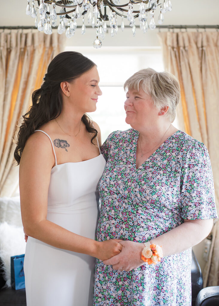 Bride and her mother share an emotional moment on the morning of her garden wedding.