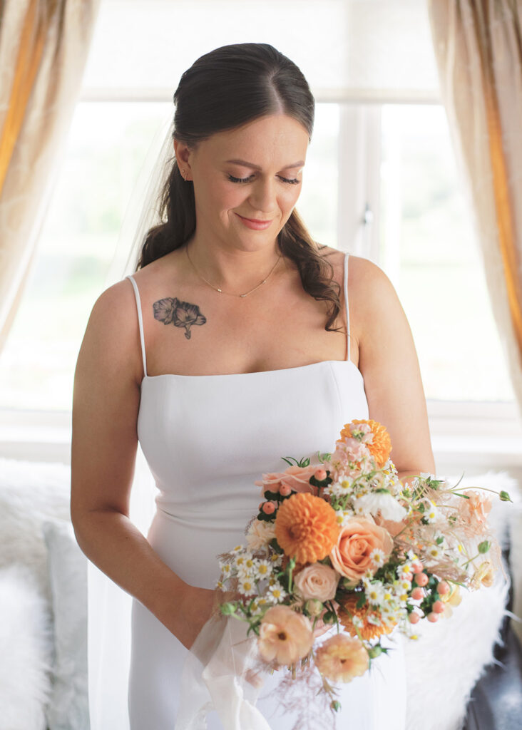 Bright indoor portrait of the bride and her bouquet.