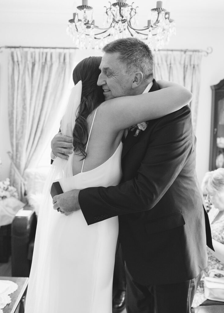 Bride and her father share a warm hug after the gift-giving.