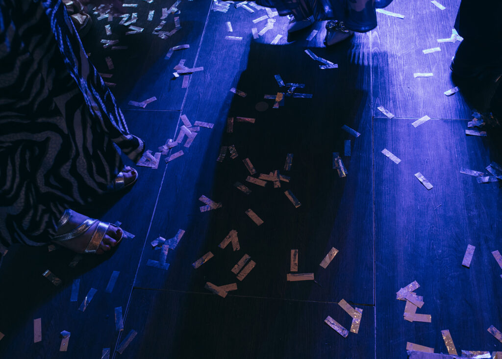 The dance floor strewn with confetti as guests dance the night away.